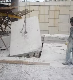 Kesilerek ayrılan büyük beton panelin zincirle kontrollü biçimde indirilmesi ve yıkım alanında güvenli şekilde kaldırılması